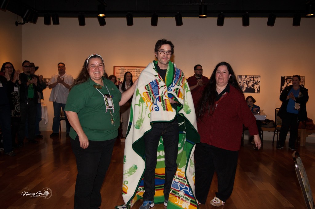 Judy and Shannon present Omar with a Pendleton blanket