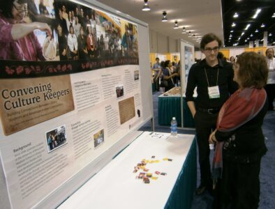 Omar Poler and Loriene Roy converse at the poster session.