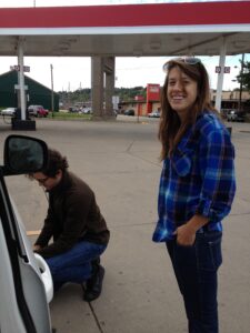 Omar checks the deflating tire pressure while Robin provides moral support