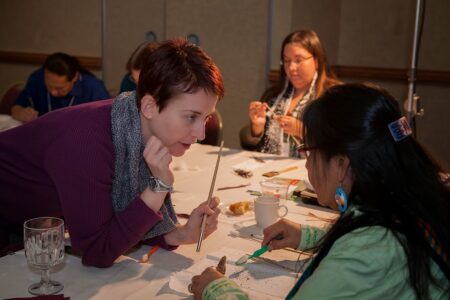 Nicole talking with Bethany in the "Cleaning Feathers" workshop