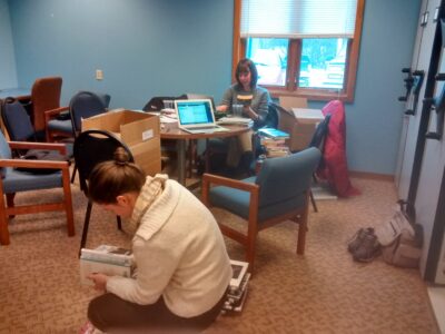 Sam and Kathryn catalog and sort books