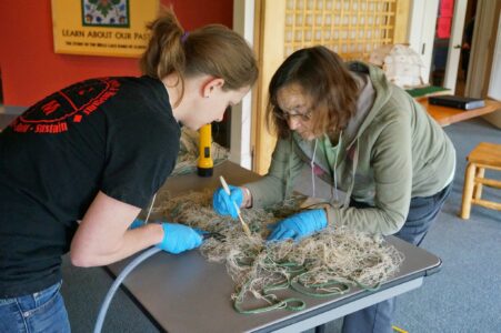 Carmella and Loretta cleaning a net