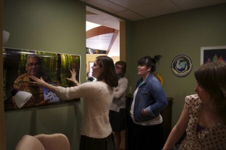 Do I Have That Straight?: Sam Link (center) positions a poster as (from left) Brenna Degan, Cassy Keyport, and Carmella Hatch offer feedback.