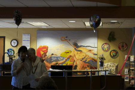 From the Heart: Dee Gokee-Rindal invites Louise Robbins up to speak. As their words and gestures testified, the two developed a close relationship over the years that has helped SLIS and Red Cliff come together to support the library project and enrich the lives of everyone involved.